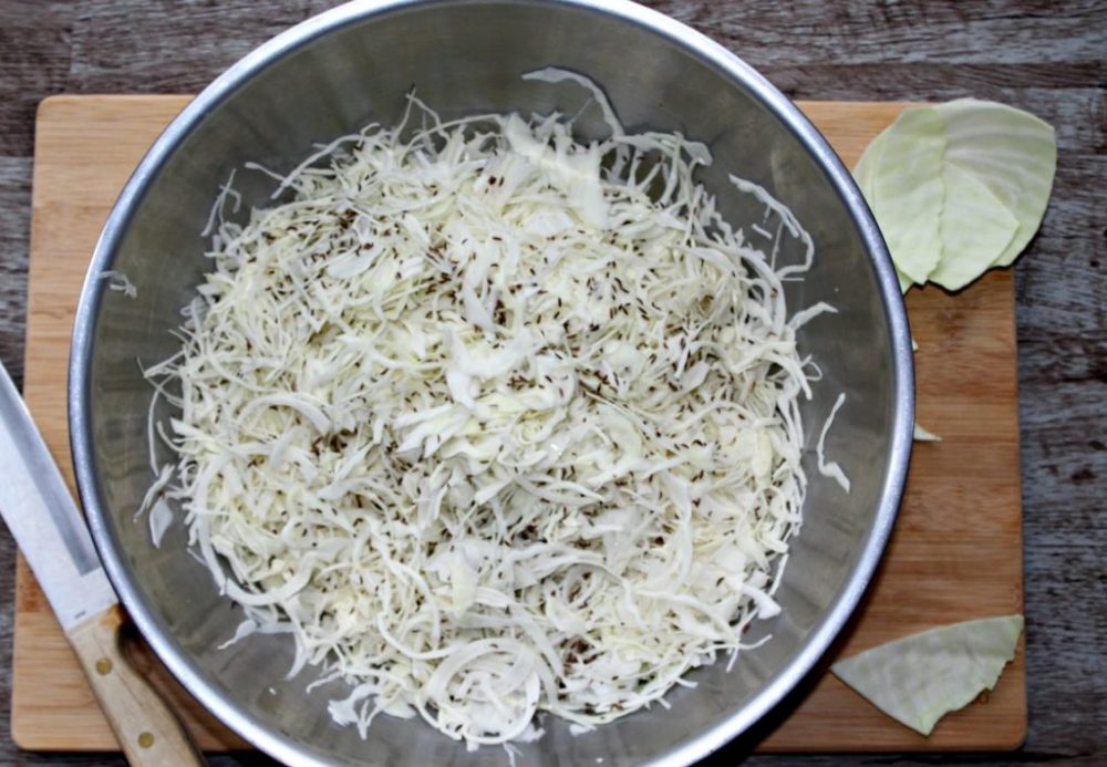 homemade sauerkraut process step 2 shredded cabbage in a large mixing bowl