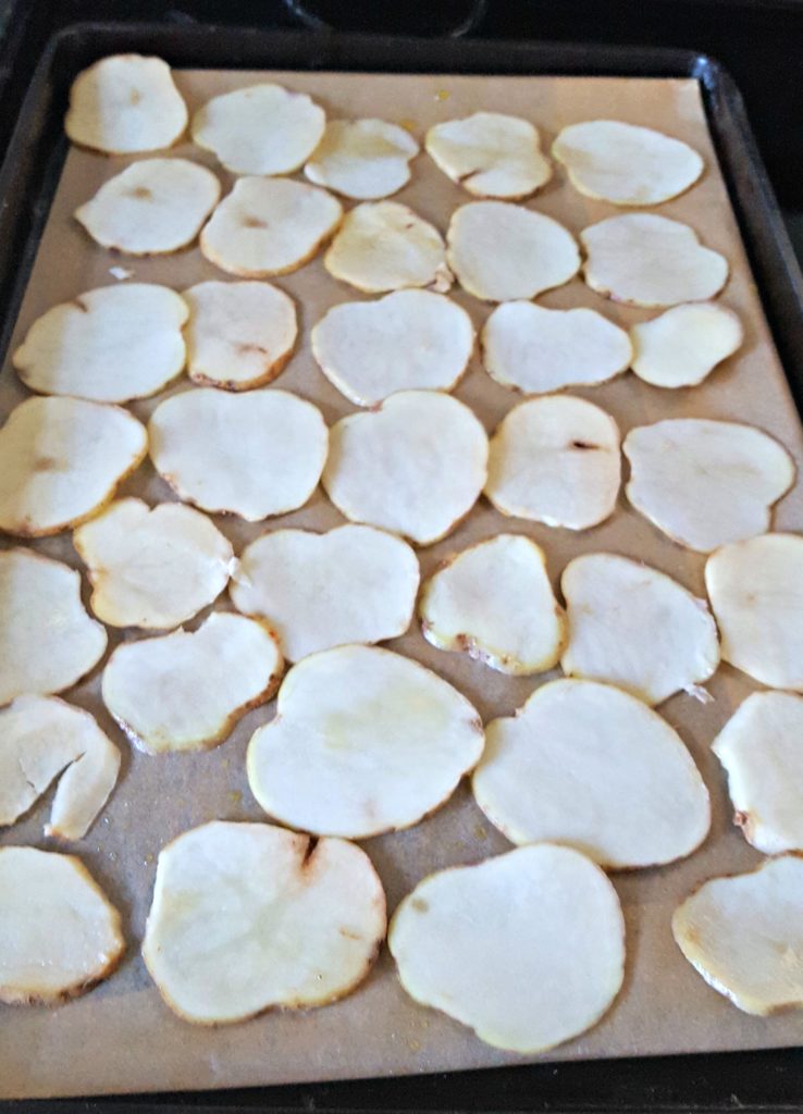 slices of potatoes on a baking sheet