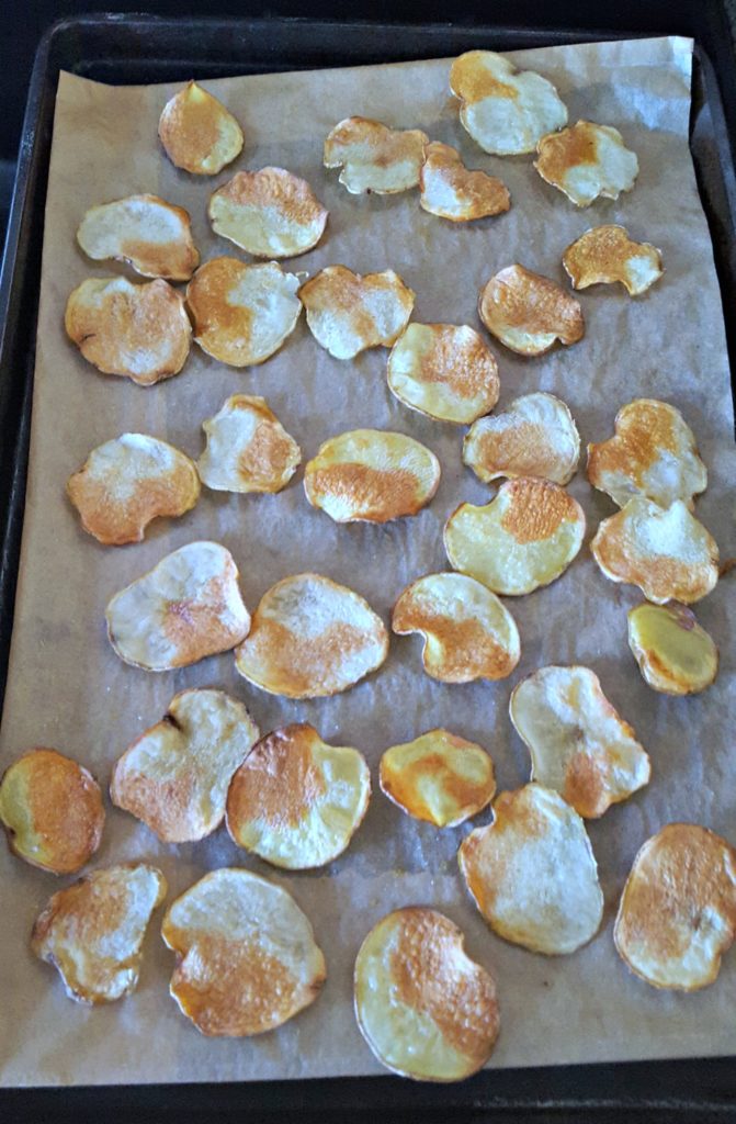 sliced potatoes on a sheet pan that are cooked