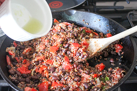 stuffing for stuffed peppers in a pan with lime juice pouring in