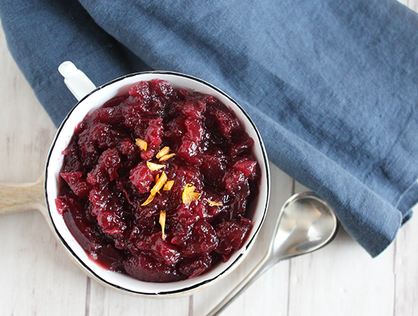 A veiw of homemade cranberry sauce in a bowl with a spoon