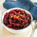 A close up view of homemade cranberry sauce topped with orange zest