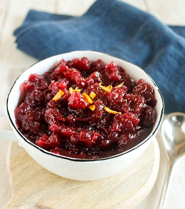 A close up view of homemade cranberry sauce topped with orange zest