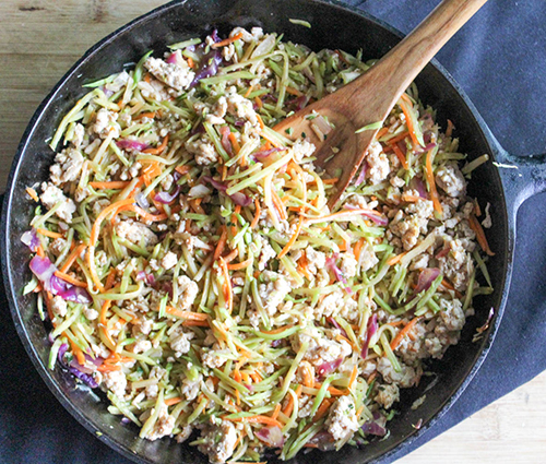 a skillet with ground chicken and broccoli slaw