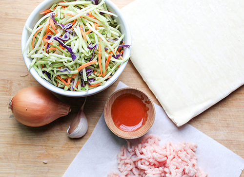 the recipe ingredients broccoli slaw, hot sauce with butter, ground chicken, garlic and oniono