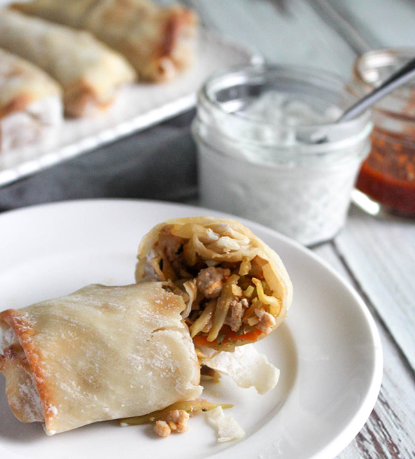 Egg roll stuffed with buffalo chicken and broccoli slaw broken in half