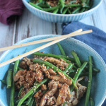 spicy green beans and pork in a blue bowl with chop sticks