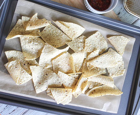 tortilla chips arranged on a baking sheet