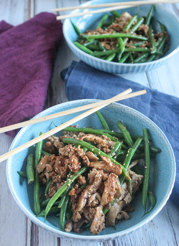 green beans and pork stiry fry in a bowl with chop sticks