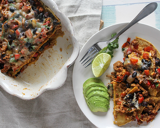 Chicken and black bean casserole in a casserole dish overhead with fork 