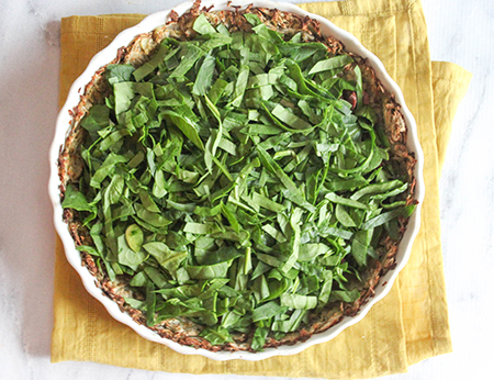 spinach in quiche crust on a table