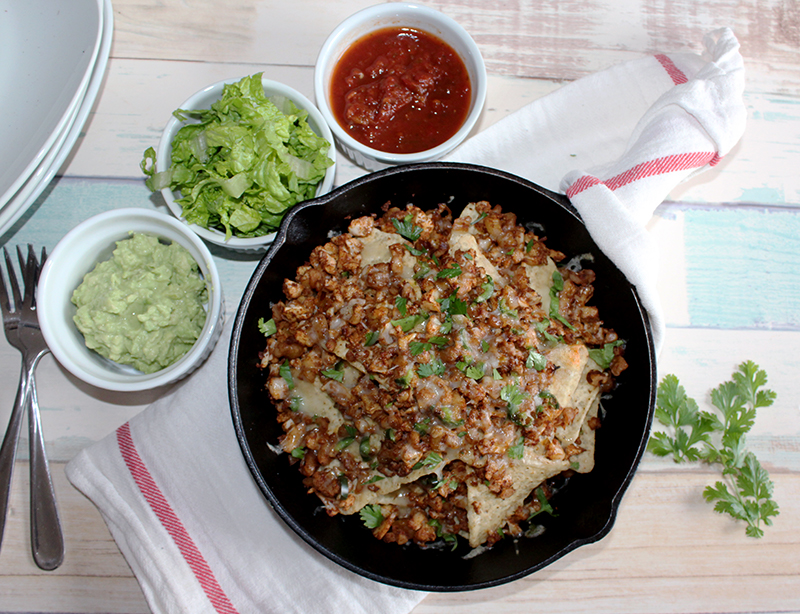 A view looking down at vegetarian nachos in a skillet