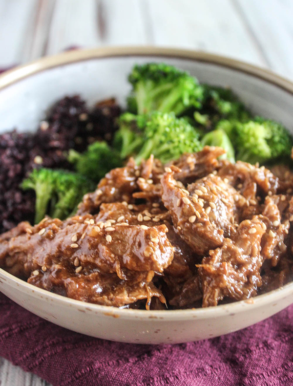 Asian pork in a bowl with broccoli and black rice