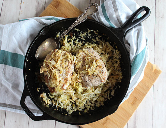 Pork Chops with apples and sauerkraut in a skillet simple and savory