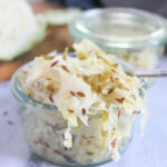 a jar overflowing with sauerkraut