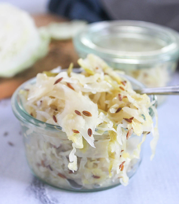 a jar overflowing with sauerkraut