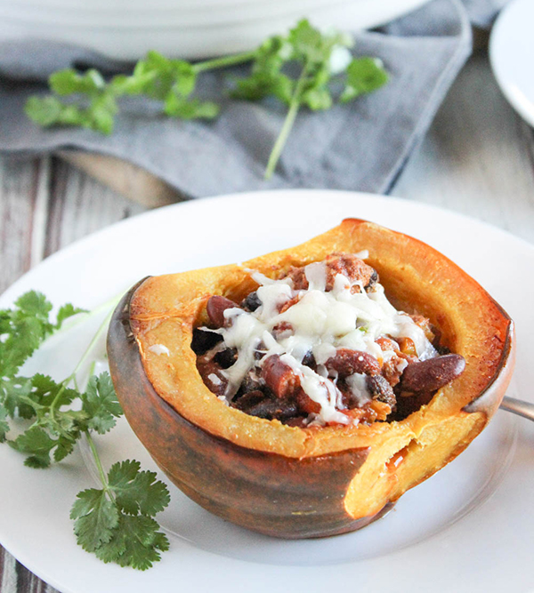 a half of an acorn squash stuffed with ground turkey and cheese