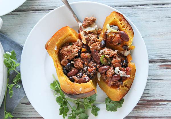 an overhead shot of stuffed squash on a plate with a fork