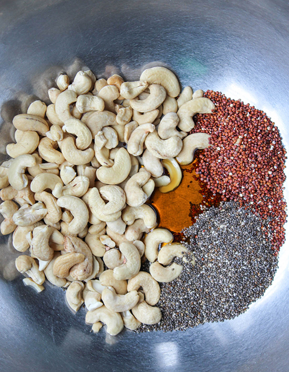 The ingredients for glazed cashews in a mixing bowlin a mixing bowl