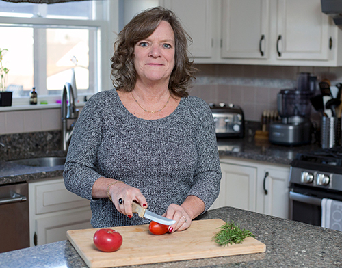 a picture of me slicing tomatoes in my kitchen