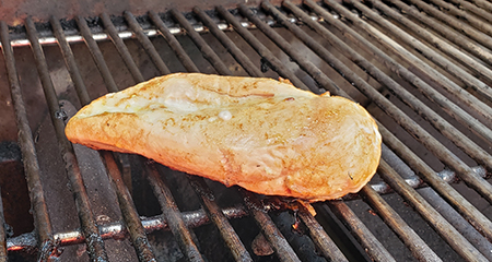 Chicken cooking on grill