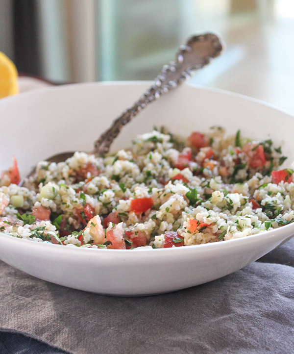 cauliflower tabbouleh salad in a bowl with a spoon