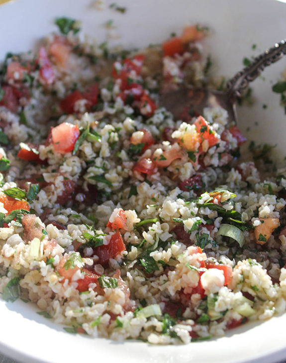 a close up view of cauliflower tabboulhe in a bowl