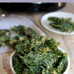 kale chips in a bowl and a plate of chips in the background