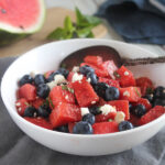 Red white and blue salad in a bowl with a spoon