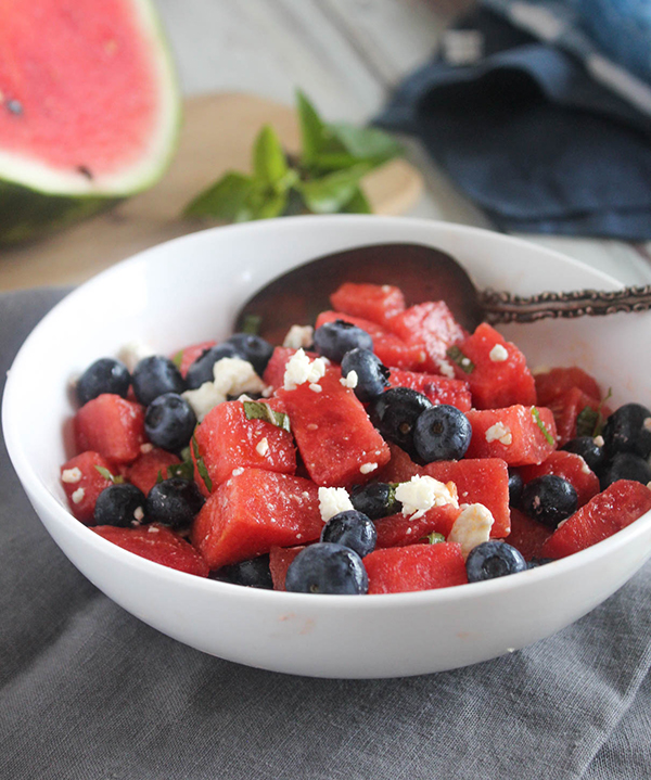 Red white and blue salad in a bowl with a spoon