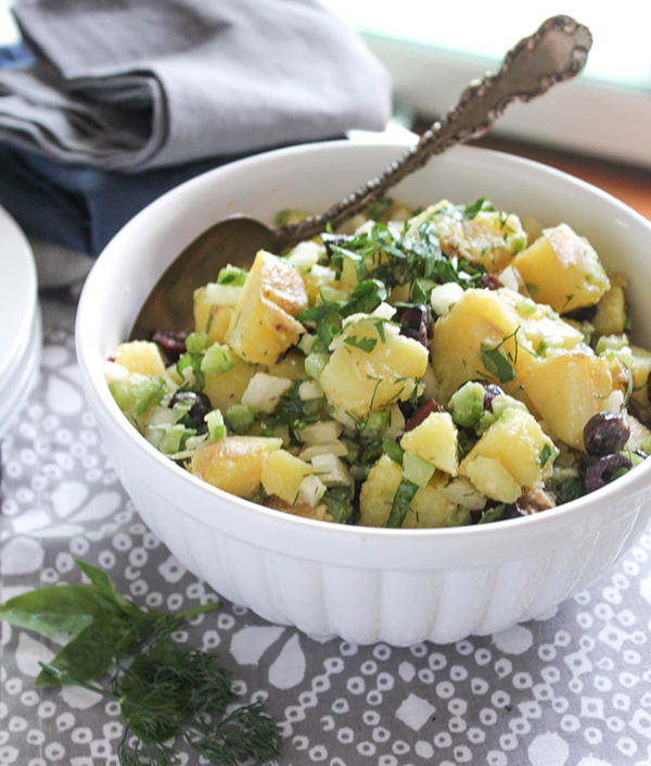 healthy potato salad in a bowl with a spoon 