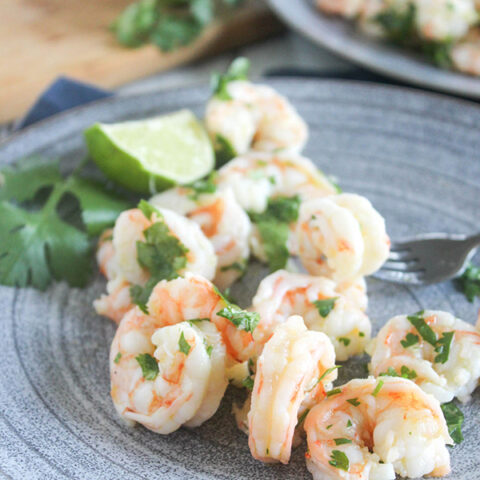 cilantro lime shrimp with a lime slice on a plate