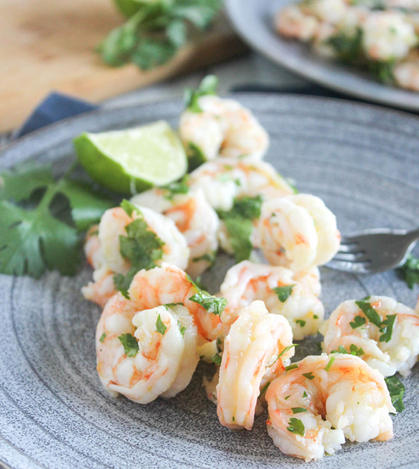 cilantro lime shrimp with a lime slice on a plate