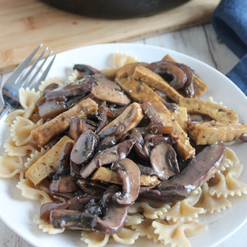 mushroom stroganoff with tofu on a plate with pasta