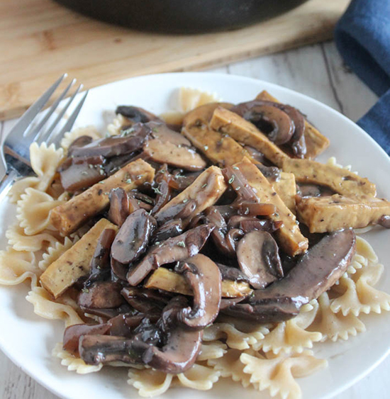 mushroom stroganoff with tofu on a plate with pasta 