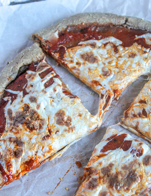 homemade sliced  pizza on parchment paper