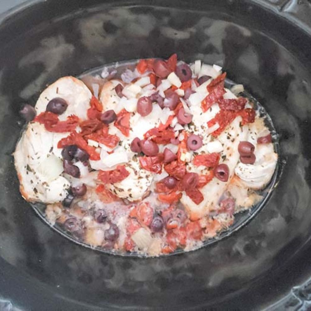 fully cooked mediterranean chicken in a slow cooker