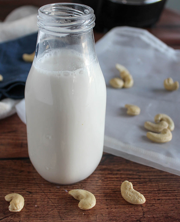 cashew milk in a milk bottle close up