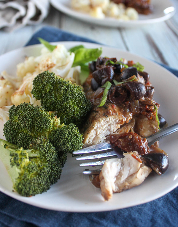 Slow cooker Mediterranean on a plate with broccoli and a fork