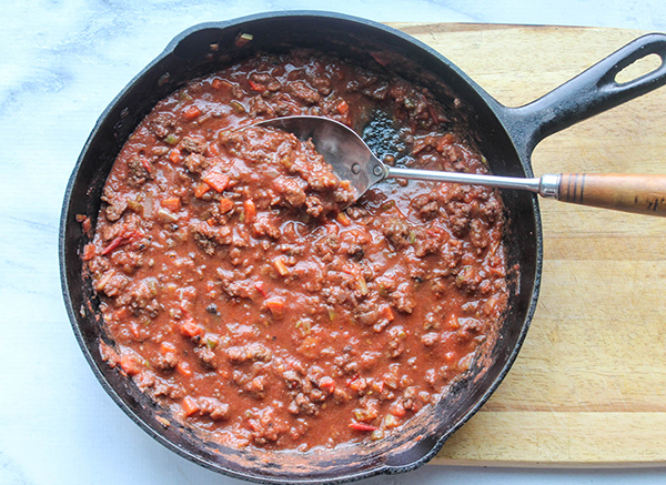 bolognese saue in a pan with a spoon