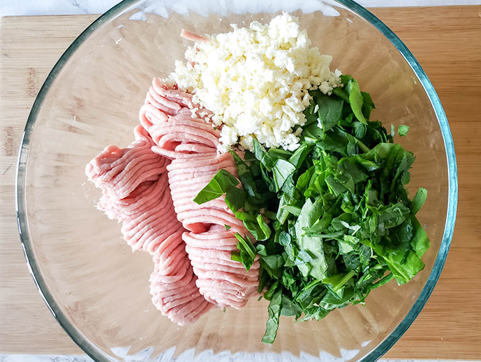 spinach, oregano, cheese and turkey in a bowl