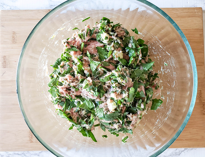 turkey mixed with spinach and cheese in a bowl