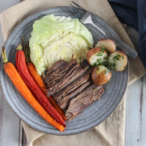 corned beef and cabbage on a plate with carrots and potatoes