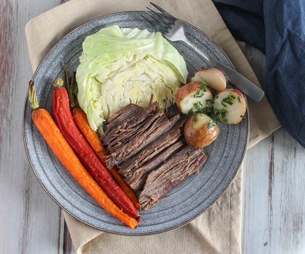 corned beef and cabbage on a plate with carrots and potatoes