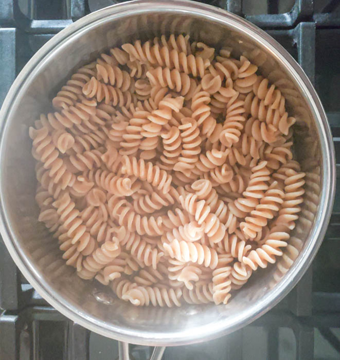 a view of pasta cooking in a pan on the stove