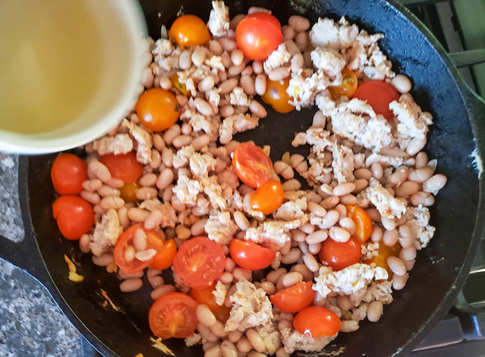 ground chicken cooking in pan adding wine