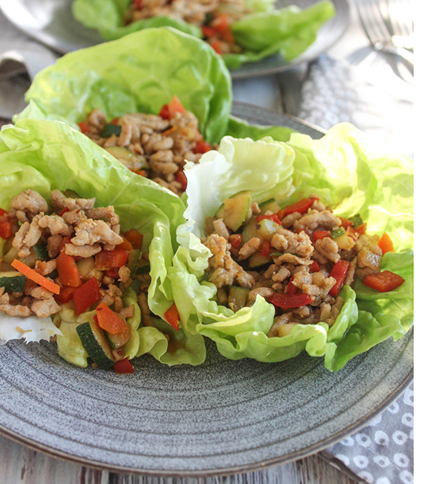 Three Asian chicken lettuce wraps on a plate