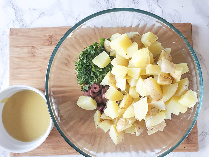 potatoes, ollives, herbs in a bowl