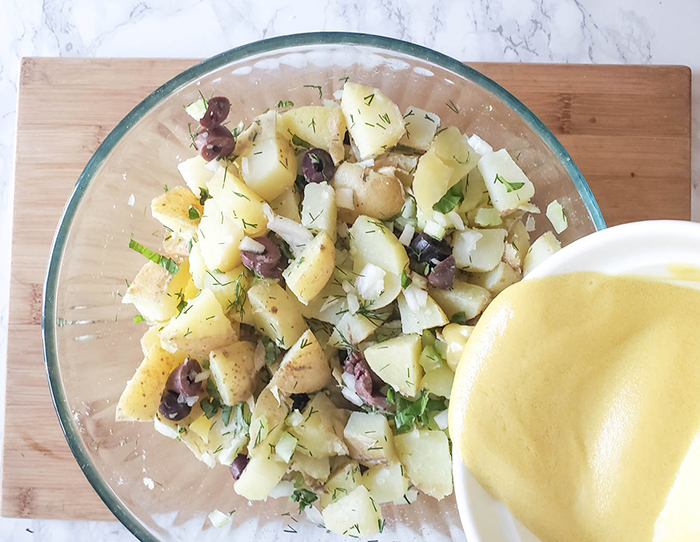 dressing pouring over the potato salad