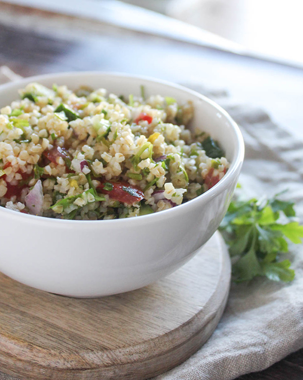 tabbouleh saald in a bowl with a side of parsley